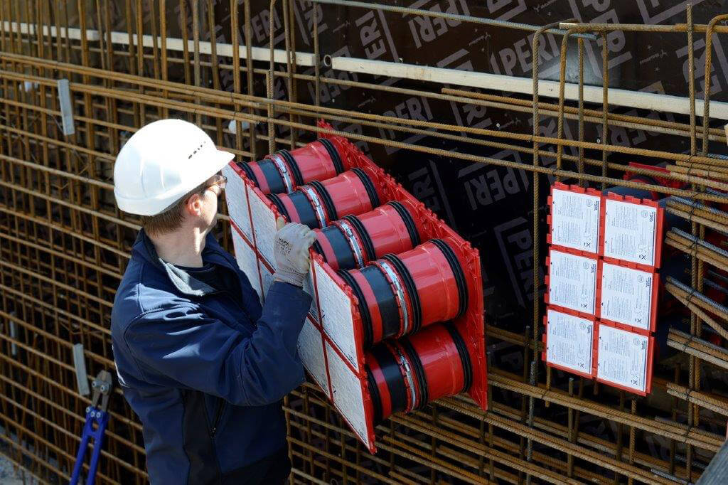 a worker installing a varia duct bank into a building