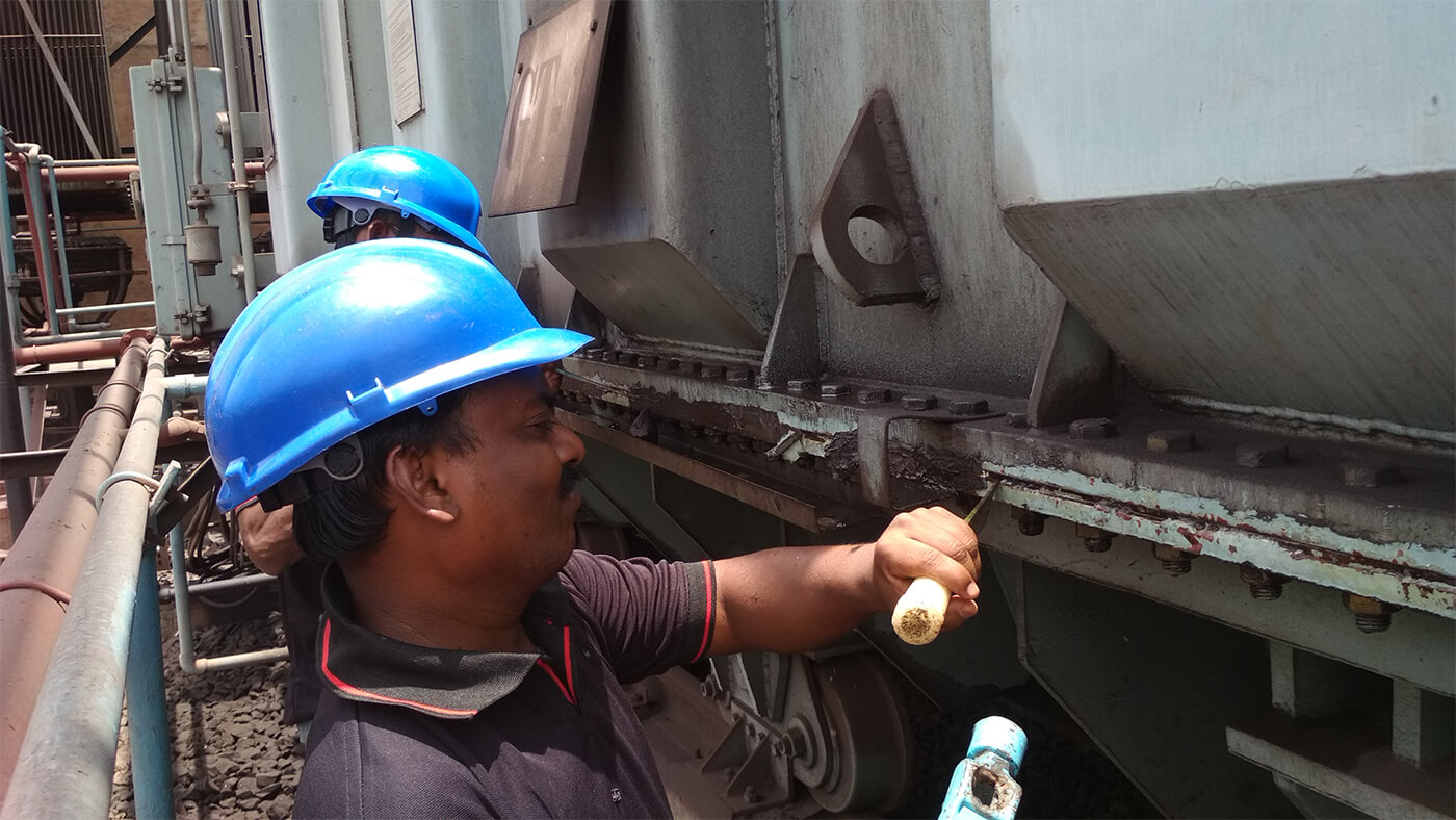 A worker removes a previous broken leak repair