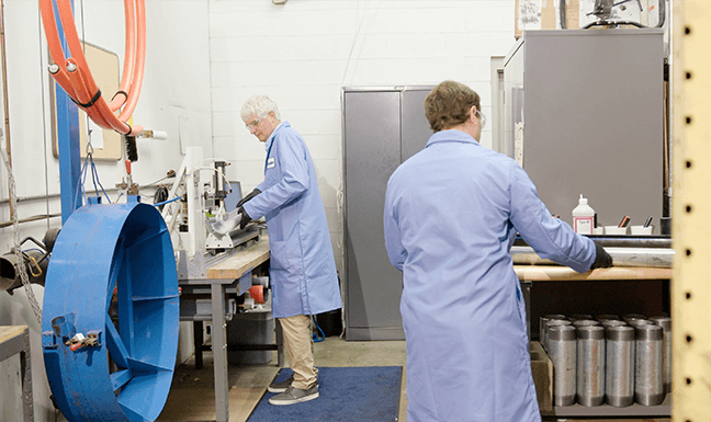 Two scientists test cable on a friction testing machine