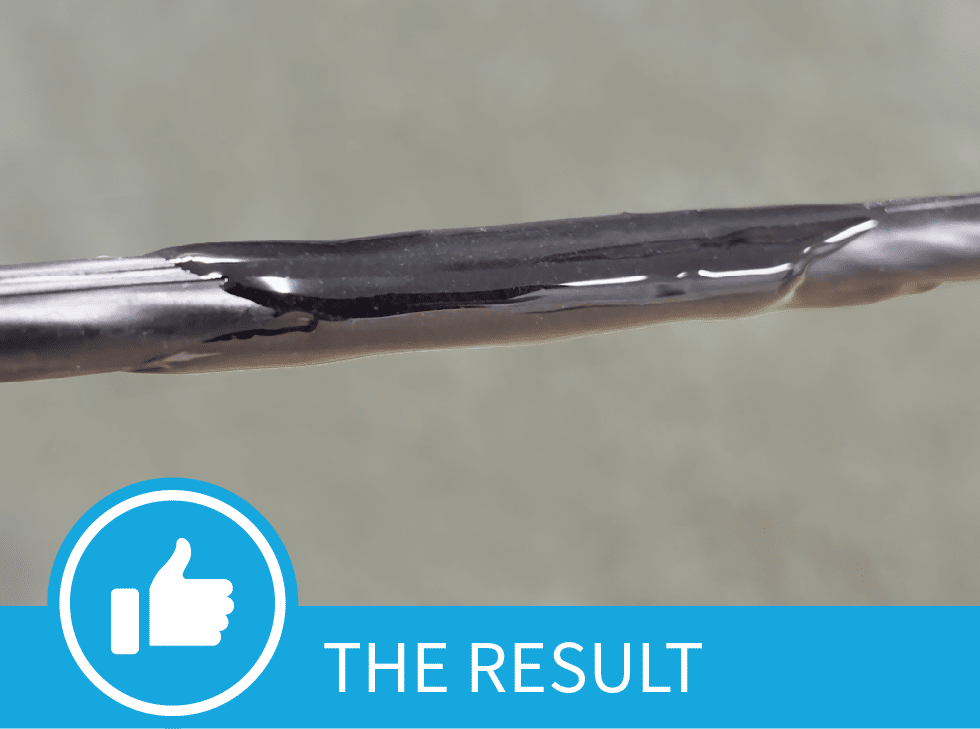 A damaged fiber cable jacket repaired by Polywater CJR. The bottom of the picture shows the words,