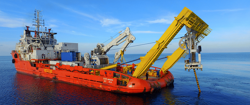 A red submarine cable deployment or inspection ship.